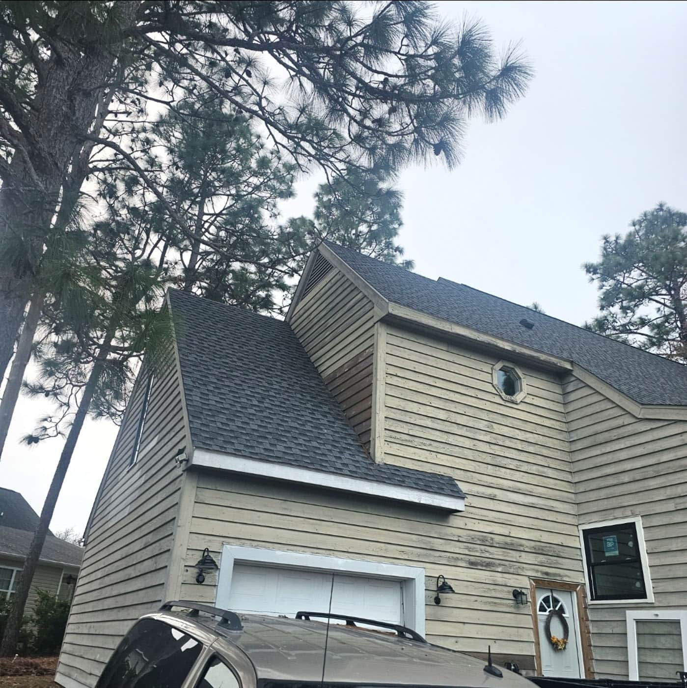 Roofline and wood siding of a coastal home exterior